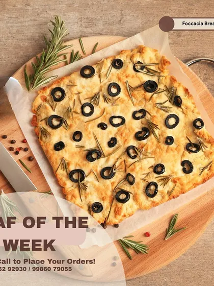 Olive and rosemary focaccia fills the board in this earlier product feature, one of the loaves in our bread range.