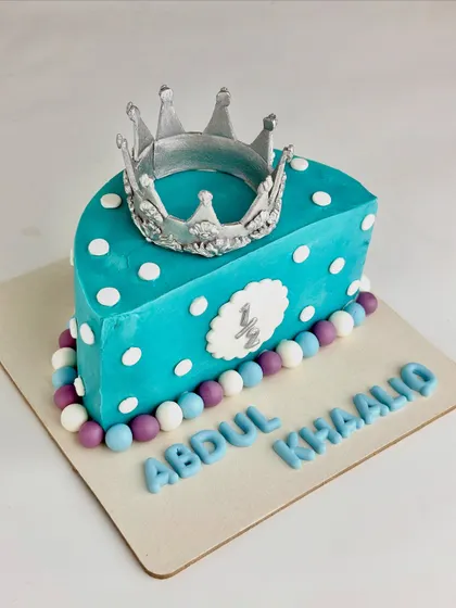 An angled view of the half-birthday cake, highlighting the handcrafted silver crown.