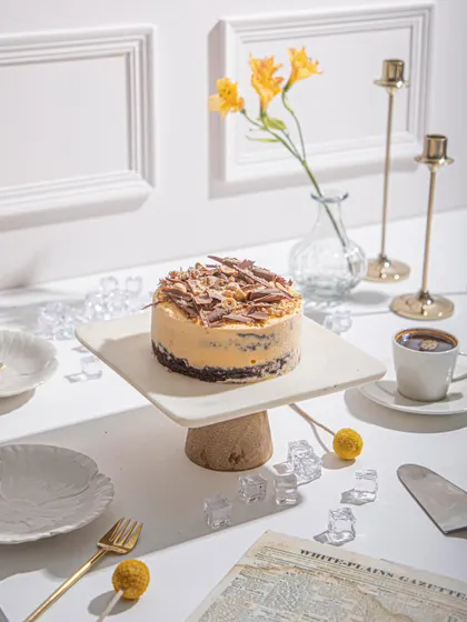 Our Mango and Chocolate Ice Cream Cake, ready to be served with coffee. It’s a versatile dessert that’s perfect for any time of day.
