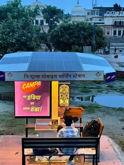 A view of our solar charging station at Ram ki Paidi, with the historic ghats of Ayodhya in the background. Our installations are designed to complement their surroundings while providing modern conveniences.