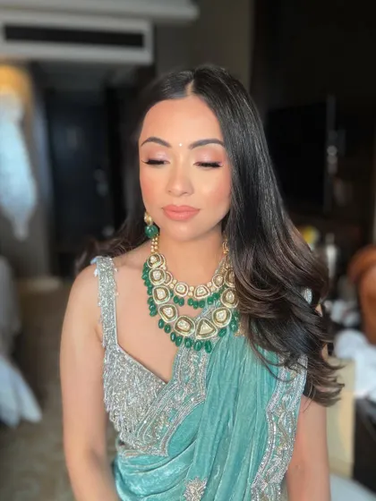 A close-up of the soft, peachy-pink eyeshadow, which adds warmth and dimension to her eyes.