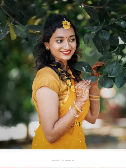 A beautiful, candid portrait of the bride amidst the greenery, her smile glowing with happiness.