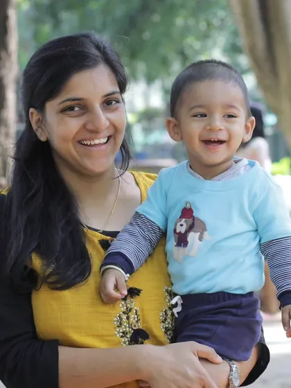 Children and mothers are bound by the beating of each other's hearts. This photo captures the beautiful, smiling connection between a mother and her child in a park.