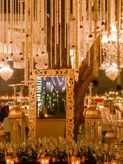 A detail shot showing an ornate gold mirror reflecting the candlelit ambiance. This element added a touch of vintage glamour to the sangeet lounge, which was filled with traditional touches like lanterns and mogra.