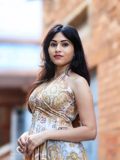 A beautiful portrait in a classic brick-lined alley. The setting adds a touch of rustic charm to her elegant look.