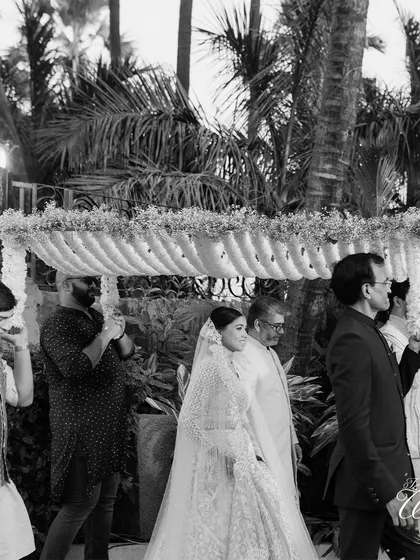 A timeless black and white photo of the bride's procession, adding a touch of classic elegance.