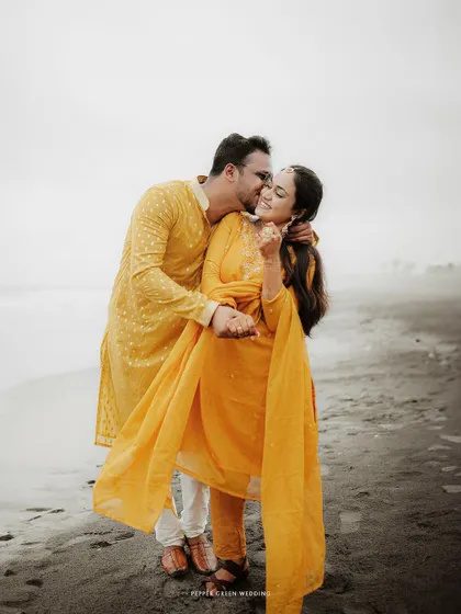 A tender kiss on the cheek for Aiswarya from Vishnu during their beach shoot. These simple gestures of affection are often the most powerful.