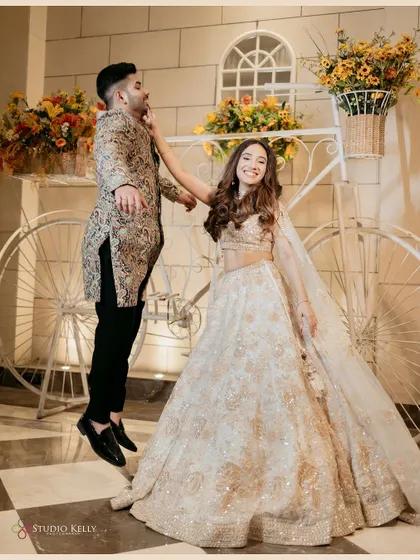 A playful and fun shot of the couple at their Sagan ceremony, with the bride playfully pulling the groom's cheek.