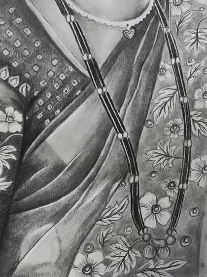A detail shot focusing on the traditional mangalsutra necklace and the floral pattern of the sari, demonstrating my attention to intricate details in clothing.