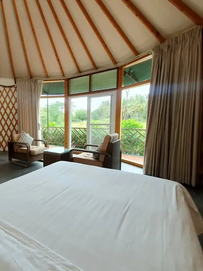The inviting bed and open-plan design of our yurt cottage, promising a restful and unique stay.