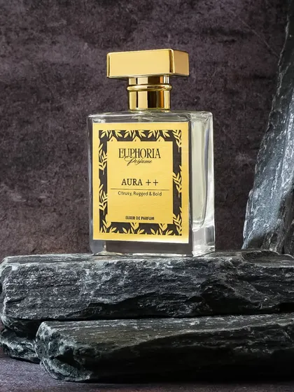 For the 'Aura ++' perfume, I used rugged black stones as a prop. This creates a strong, masculine, and elemental visual that aligns with the 'Citrusy, Rugged & Bold' character of the scent.