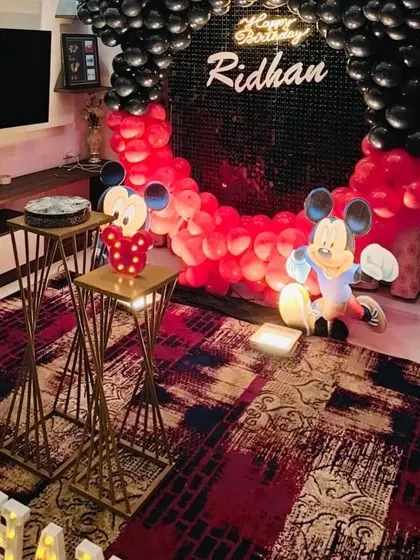 Another angle of the circular Mickey Mouse setup, showing the placement of the cake stands and character props.