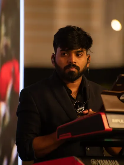 Our keyboard player watches the performance from behind the keys during the Mysuru band set.