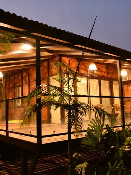 The warm lights of a cottage at night, promising a cozy and peaceful end to an adventurous day.