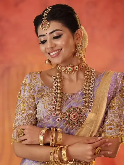 A close-up portrait of the model, showing how the custom blouse and traditional jewelry create a stunning bridal look.