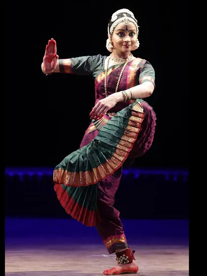 A classic Bharatanatyam pose, the 'Abhaya' mudra, offering protection and fearlessness, an attribute often associated with Lord Shiva.