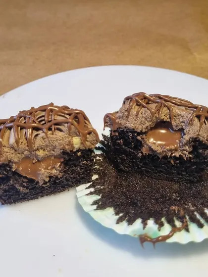 A look inside our center-filled Nutella cupcakes. A moist chocolate cupcake with a gooey Nutella center, topped with chocolate frosting.