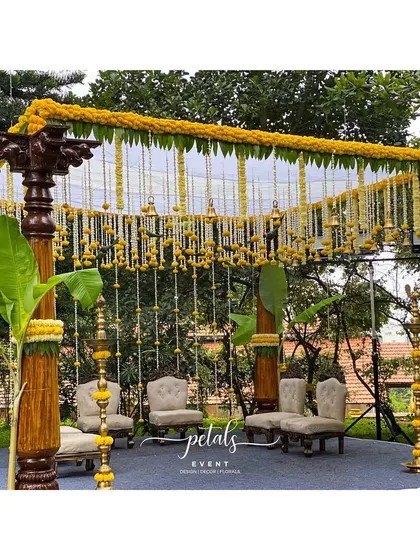 This mandap setup showcases my love for traditional elements. The rustic wooden pillars, vibrant marigolds, and the gentle sound of temple bells create a truly authentic and blissful atmosphere for the couple.