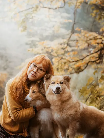 A woman and her two gorgeous dogs embraced by the magical light and colors of a foggy autumn morning. These fall mini-sessions are all about capturing cozy, intimate moments.