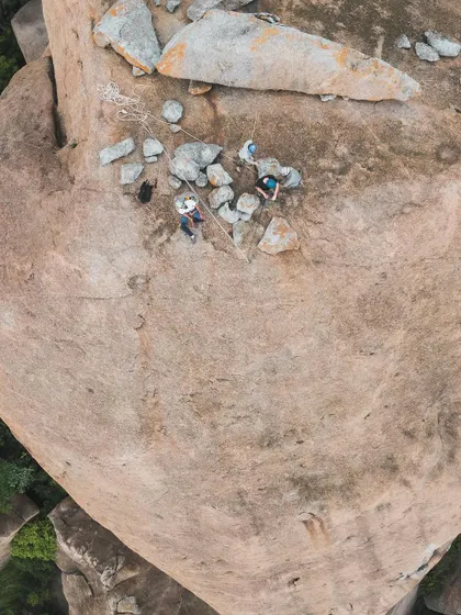 A top down drone shot of climbers relaxing on the summit of Gaali Kallu. The sense of community and shared experience is what makes these climbs special.