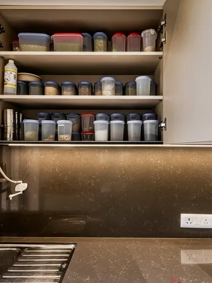 Well-organized upper cabinets for storing spices and dry goods, making them easy to find while cooking.