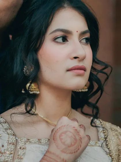 A close-up of Kavya's engagement look. The focus is on her statement eyes and flawless skin, with a touch of henna adding to the pre-wedding excitement.