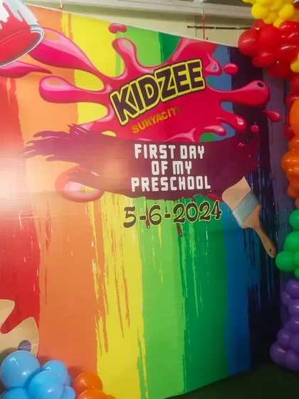 A detailed shot of the custom-printed backdrop for the Kidzee event, featuring the school's logo and event details. I can create branded materials for any corporate or school function.
