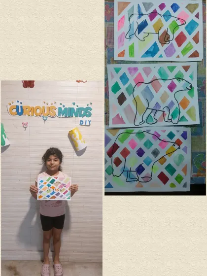 A student proudly displays her colorful polar bear artwork. This was the creative part of our Arctic Habitat session, where she used her imagination to paint a beautiful scene.