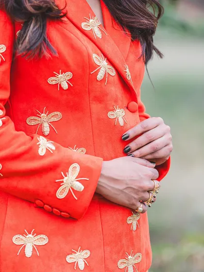 Another detail shot showcasing the delicate, handcrafted bee embroidery.