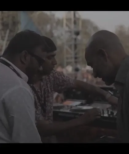 A behind-the-scenes moment, coordinating with the team before hitting the stage at a Holi festival.