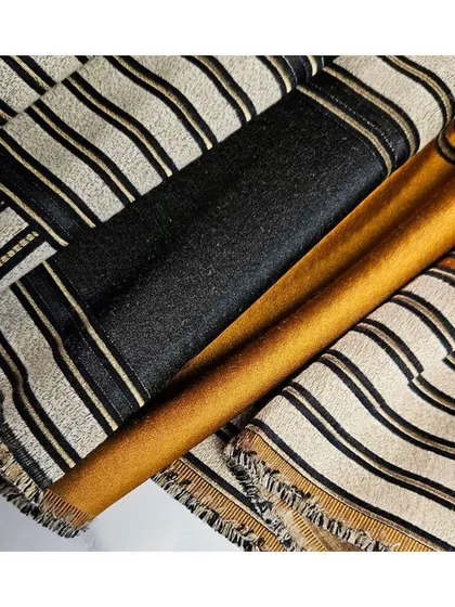 'Bau' is an elegant jacquard fabric featuring matte and shiny lines, offering a modern take on a classical striped look. It is perfectly suited for creating sophisticated drapes.