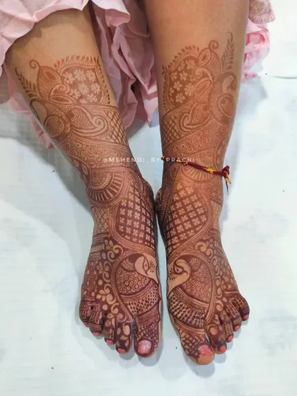 Full bridal feet mehndi featuring peacocks and intricate net patterns. This design covers the entire foot, ready for the bride to step into her new chapter.