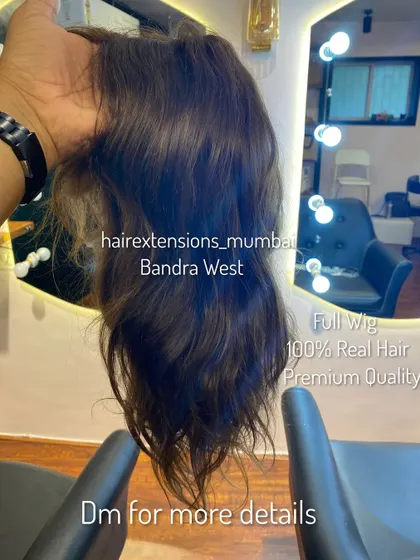 A look at one of our full wigs, held up to show the quality and natural texture of the 100% real hair we use.