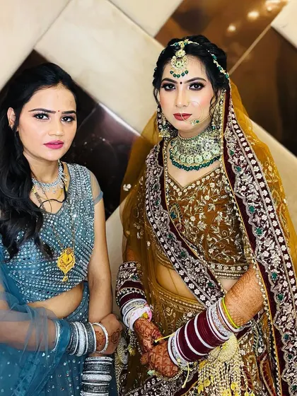 The bride with her sister, both looking beautiful. It shows my ability to create complementary looks for family members.