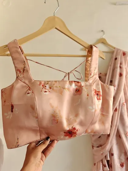 A close-up of the matching floral blouse with a stylish square neckline.