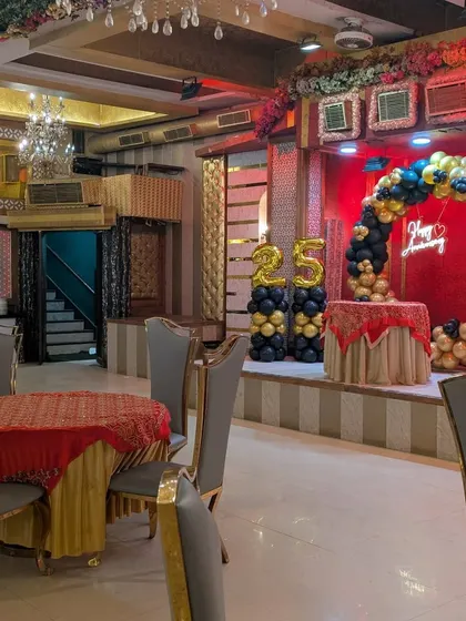 This wide shot shows how the stage decorations fit into the larger banquet hall. The setup commands attention on the stage while complementing the overall venue ambiance for a corporate celebration.