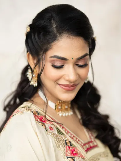 A close up with her eyes closed, showing the beautiful, soft eye makeup.