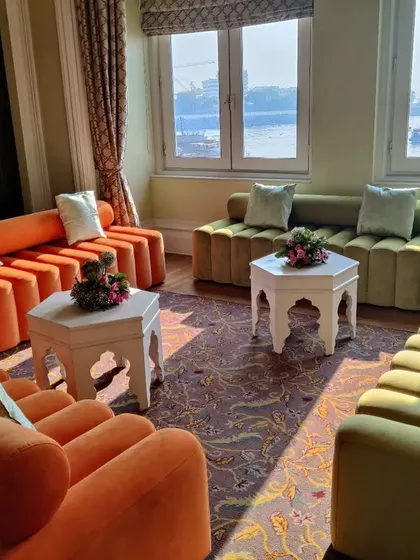 Modern, colorful lounge furniture with a stunning view of the Mumbai sea link, set up for a private Mehendi event.