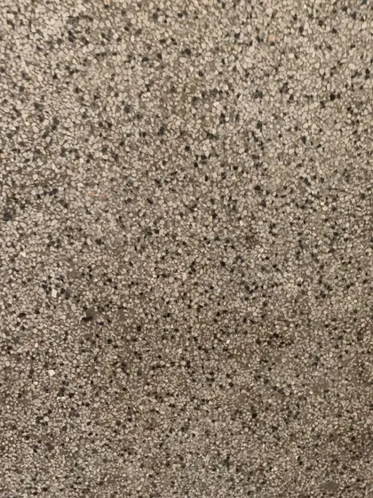 The texture of the original terrazzo flooring, a durable and beautiful material that we aim to repair rather than replace.