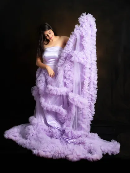 This off-shoulder lavender ruffle gown is a dreamy and romantic choice for any special occasion.