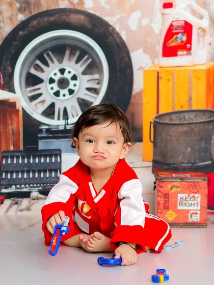 This little mechanic is taking his job very seriously. The garage-themed set, complete with tools and tires, is perfect for a child who loves to build and fix.