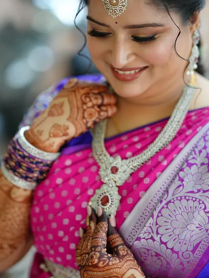 A close-up on the details, showing the intricate diamond and ruby necklace and how the makeup tones harmonize with it.