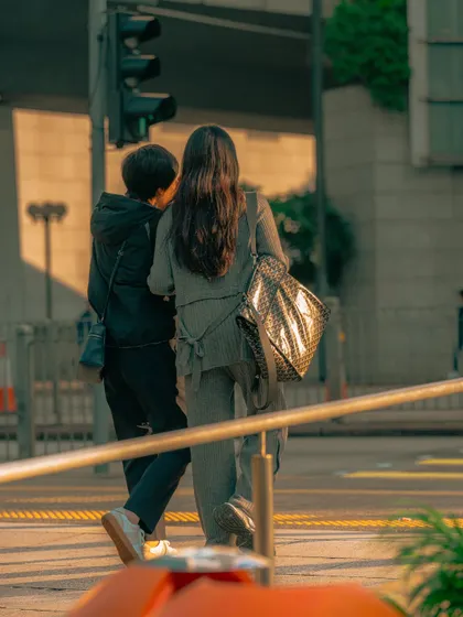 A candid shot of people crossing the street, bathed in the warm light of the setting sun. The golden hour is my favorite time to shoot for its beautiful, soft light.