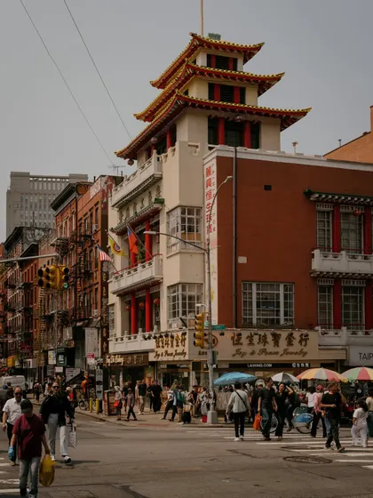 The unique pagoda-style roof of a building on a corner in Chinatown. This shot highlights the distinct architectural landmarks that define different parts of New York City.