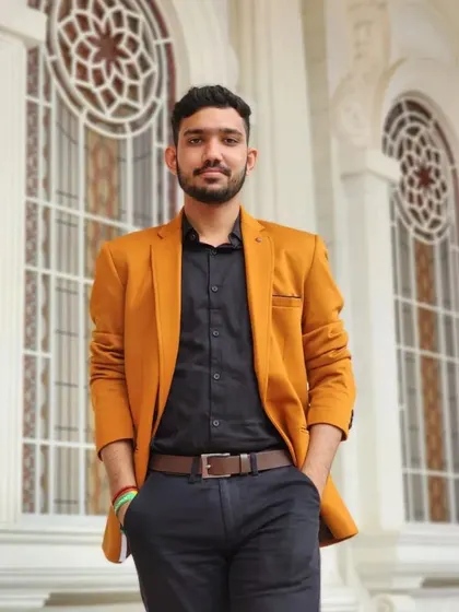A tan blazer is a versatile addition to any wardrobe. Here it's paired with a black shirt for a sharp, contemporary look.