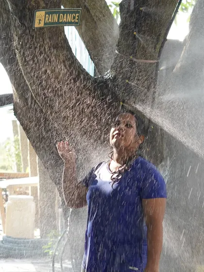 A guest enjoying a moment of peace under the showers in our rain dance area. It's a great way to cool down and feel refreshed.