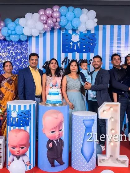 A happy family photo with a pastel blue and purple Boss Baby theme.