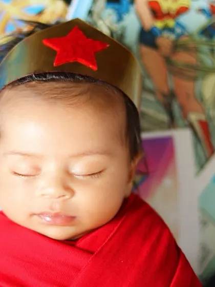 The face of a tiny superhero. This close-up on our little Wonder Woman shows her peaceful expression, crowned with her iconic red star.