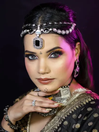 A close-up of the final look, showcasing the smokey eye and the intricate details of the traditional jewelry.