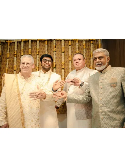 The men from both families, Indian and American, showing off their mehendi designs. A great moment of cultural exchange.